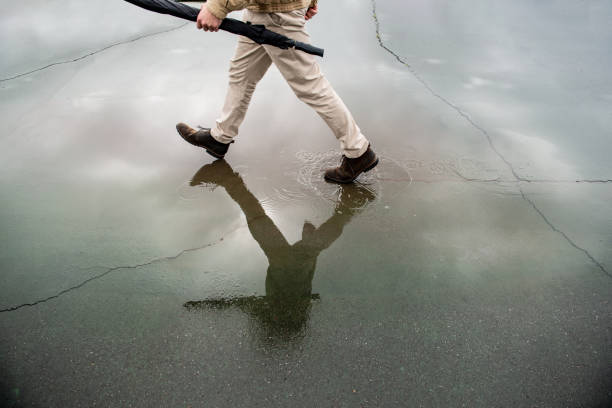 A well dressed man catching a break in the rain before the next storm rolls in.