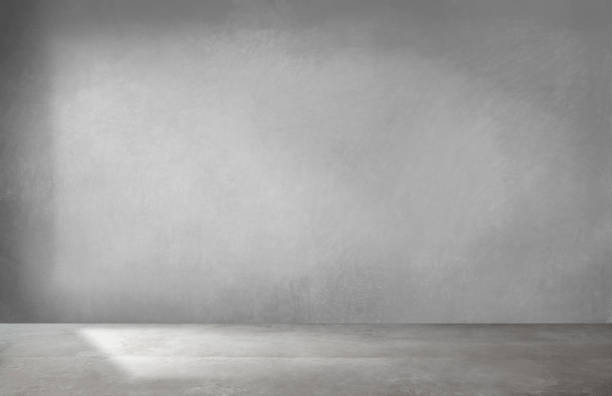 istock Gray wall in an empty room with concrete floor 1127928984