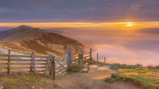 golden autumn sunrise above the clouds in the Peak District