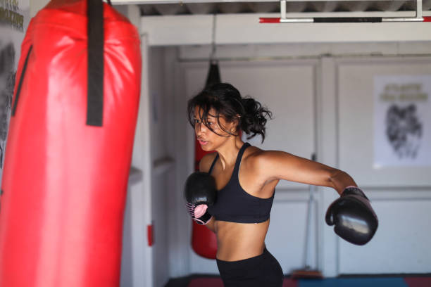 istock a Young woman training for combat sports. 1127935921