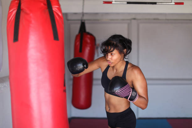 istock a Young woman training for combat sports. 1127935937