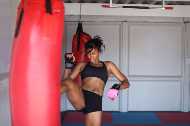 istock a Young woman training for combat sports. 1127936036
