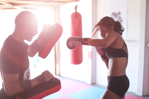 istock a Young woman training for combat sports. 1127936669