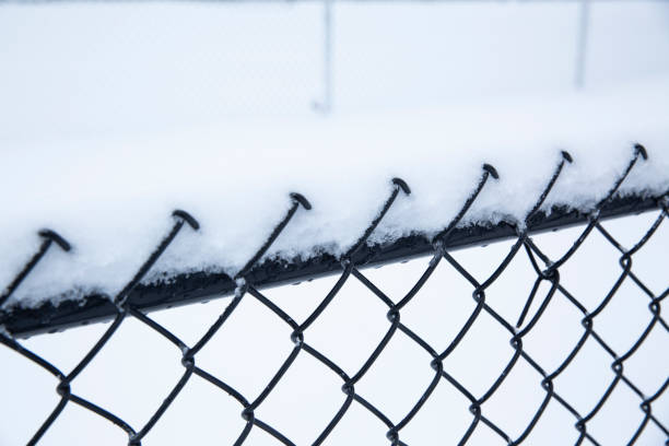 istock Chainlink fence in snow - Stock image 1127939839