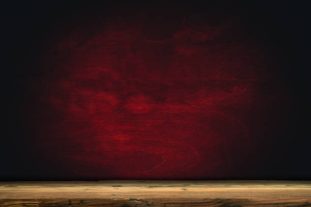 istock Old oak Wooden table and background wall. 1127940811