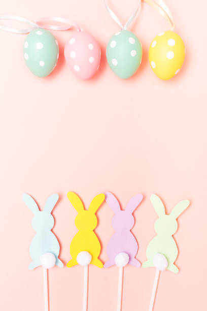istock Easter bunnies and eggs on pastel pink background 1127941875