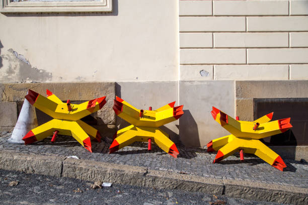Yellow and red colored anti-tank hedgehogs at the side of a road in Prague, Czech Republic.