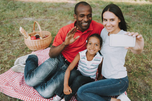 istock Multinational Family Doing A Selfie On Picnic. 1127943056