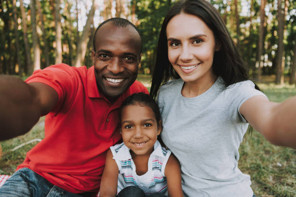 istock Multinational Family Doing A Selfie On Picnic. 1127943061