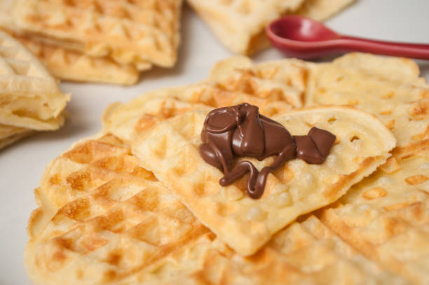 waffle in shaped heart with chocolate in a white plate