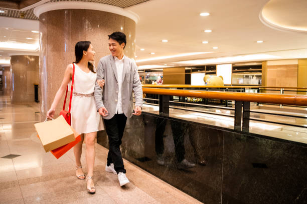 istock Couple walking together through mall 1127944118