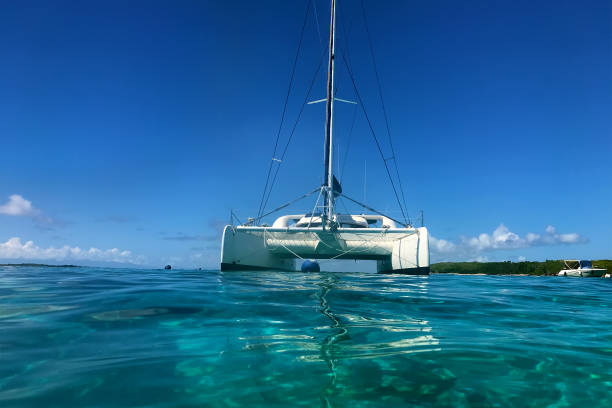 istock Swimming in  clear turquoise water near a catamaran. 1127944865