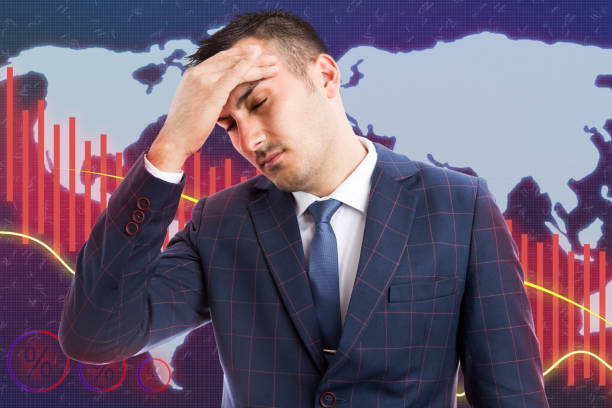 istock Broker with headache as economic decline concept 1127946154