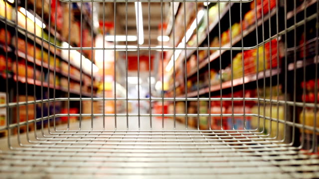 Shopping cart moving through supermarket