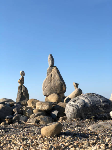 istock stone men on the rocks against blue sky in summer 1127946639