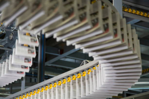 istock Conveyor belts with newspapers in printing press 1127947481
