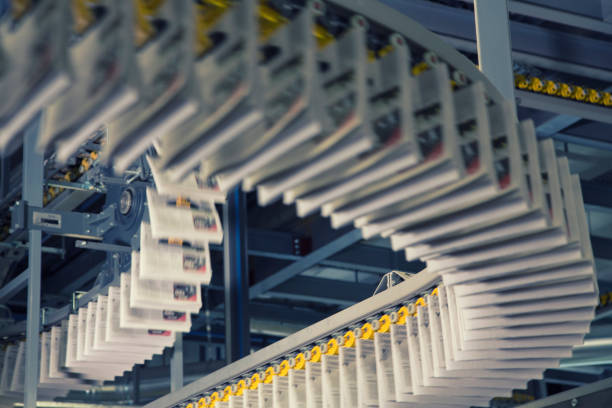 istock Conveyor belts with newspapers in printing press 1127947493