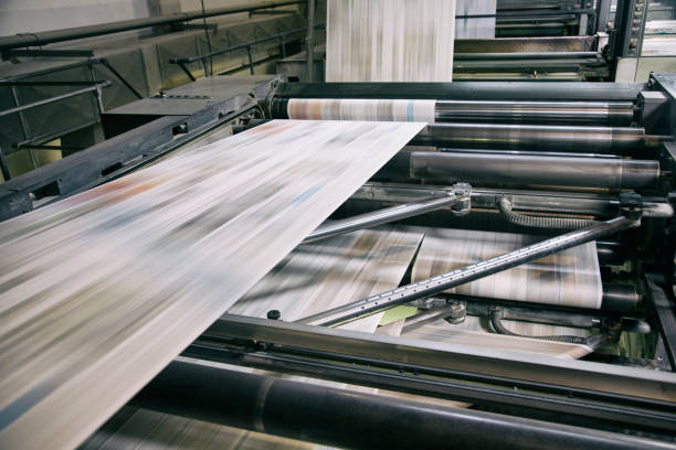 Printing newspapers Newspapers being printed in printing press. printing press stock pictures, royalty-free photos & images