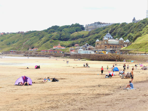 Scarborough, Yorkshire, UK. July 13, 2009. Holidaymakers enjoying the beach at low tide in front of the Spa at Scarborough in Yorkshire, UK.