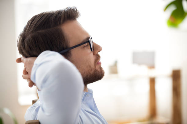 istock Relaxed happy businessman resting taking break breathing air in office 1127949996