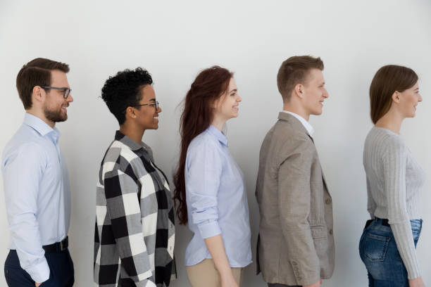 istock Side view at happy diverse business people standing in queue 1127950069