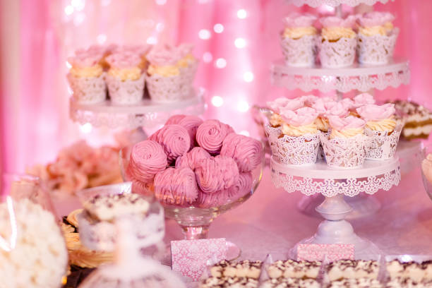 istock handmade sweets in cups on stands on a pink background, marshmallows and cream cake 1127950821