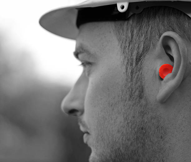 ear protection on a construction worker stock photo