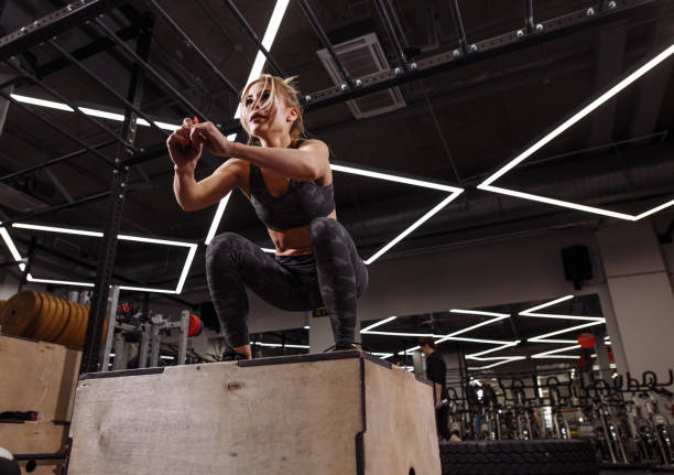 fit young ambitious woman doing a box jump exercise.