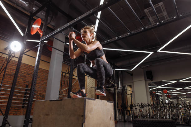 istock hardworking fit girl working out with wooden box. 1127952510