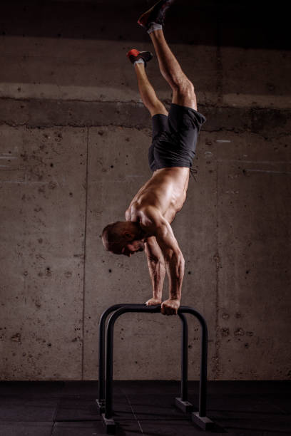 istock dynamic exercises with p-bars. sport equipment concept 1127955842