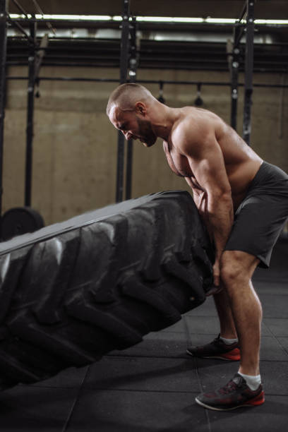 istock angry shirtless bodybuilder can't flip the tire 1127955893