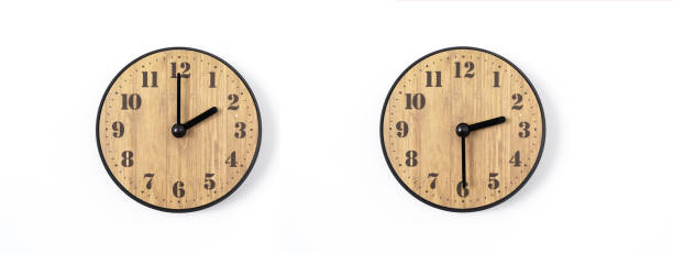 istock wood office wall clock with white dial on white background. wall clock on white background, top view. 1127956081