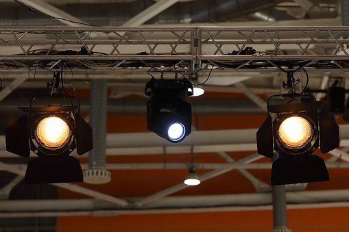 Various stage lights hanging on a truss.