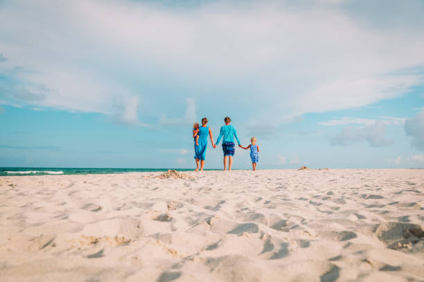 istock happy family with kids walk on beach 1127961296
