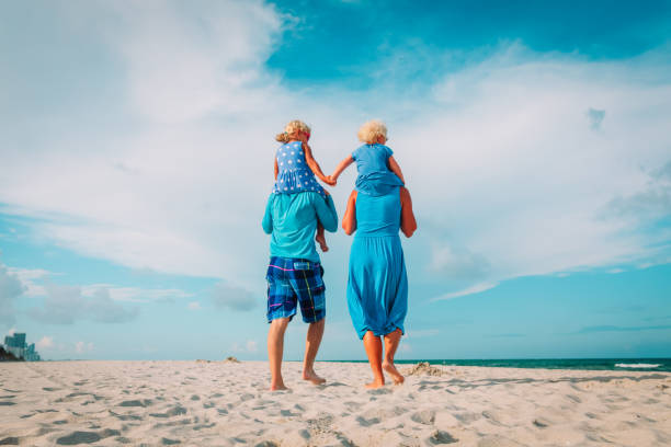 istock happy family with kids walk on beach 1127961347
