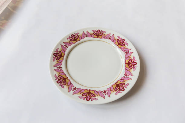istock a white round plate with floral and line pattern on white background 1127961511