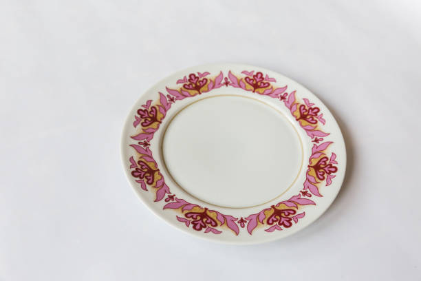 istock a white round plate with floral and line pattern on white background 1127961598