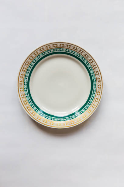istock a white round plate with floral and line pattern on white background 1127961676