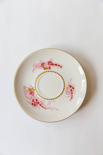 istock a white round plate with floral and line pattern on white background 1127962345