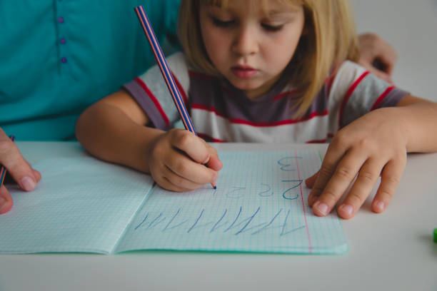istock father teaching daughter how to write numbers 1127962662
