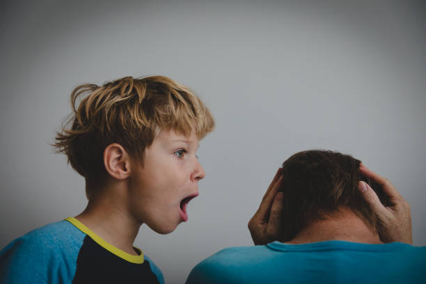 istock tired father and son shouting at him, problems in family 1127962788