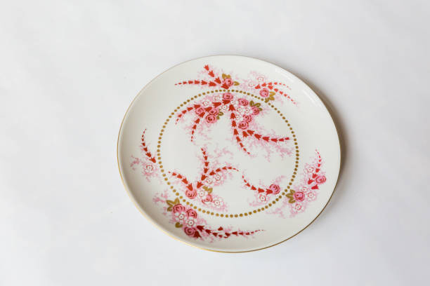 istock a white round plate with floral and line pattern on white background 1127962947
