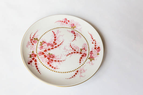 istock a white round plate with floral and line pattern on white background 1127962954