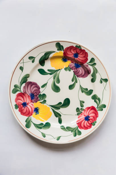 istock a white round plate with floral and line pattern on white background 1127963010