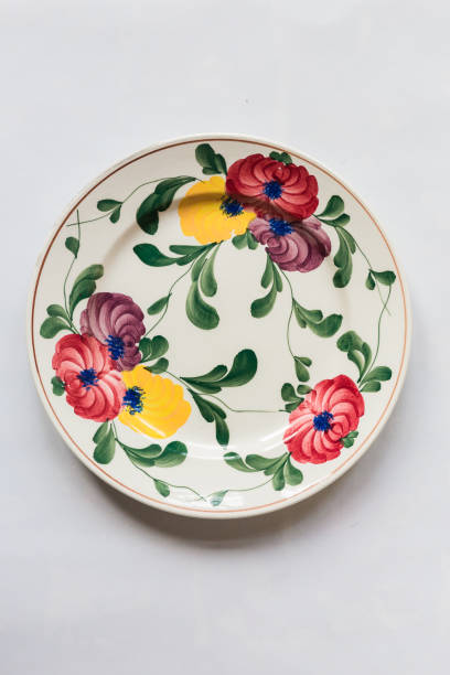 istock a white round plate with floral and line pattern on white background 1127963048