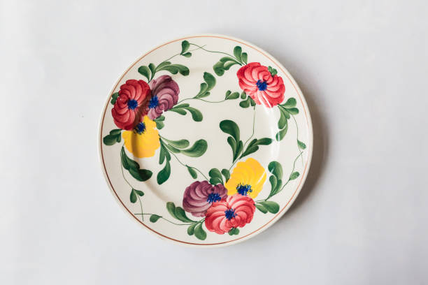 istock a white round plate with floral and line pattern on white background 1127963561