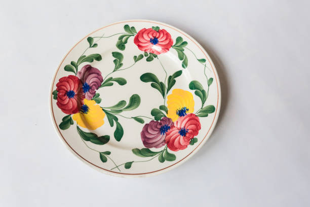 istock a white round plate with floral and line pattern on white background 1127963610