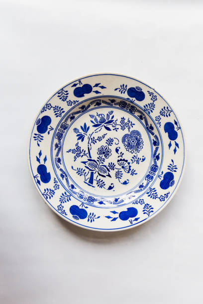 istock a white round plate with floral and line pattern on white background 1127963684
