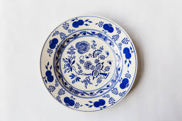 istock a white round plate with floral and line pattern on white background 1127963733