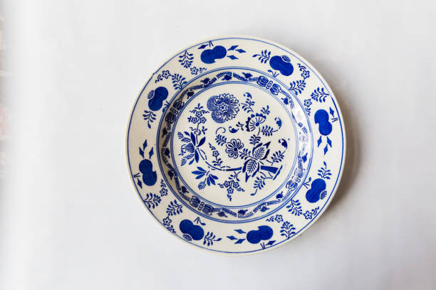 istock a white round plate with floral and line pattern on white background 1127963735